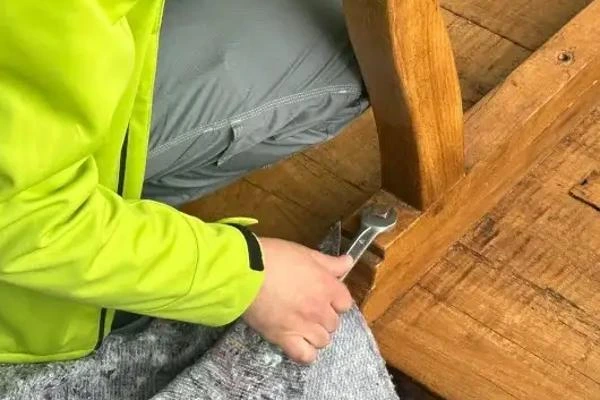 Umzugshelfer demontiert einen Tisch